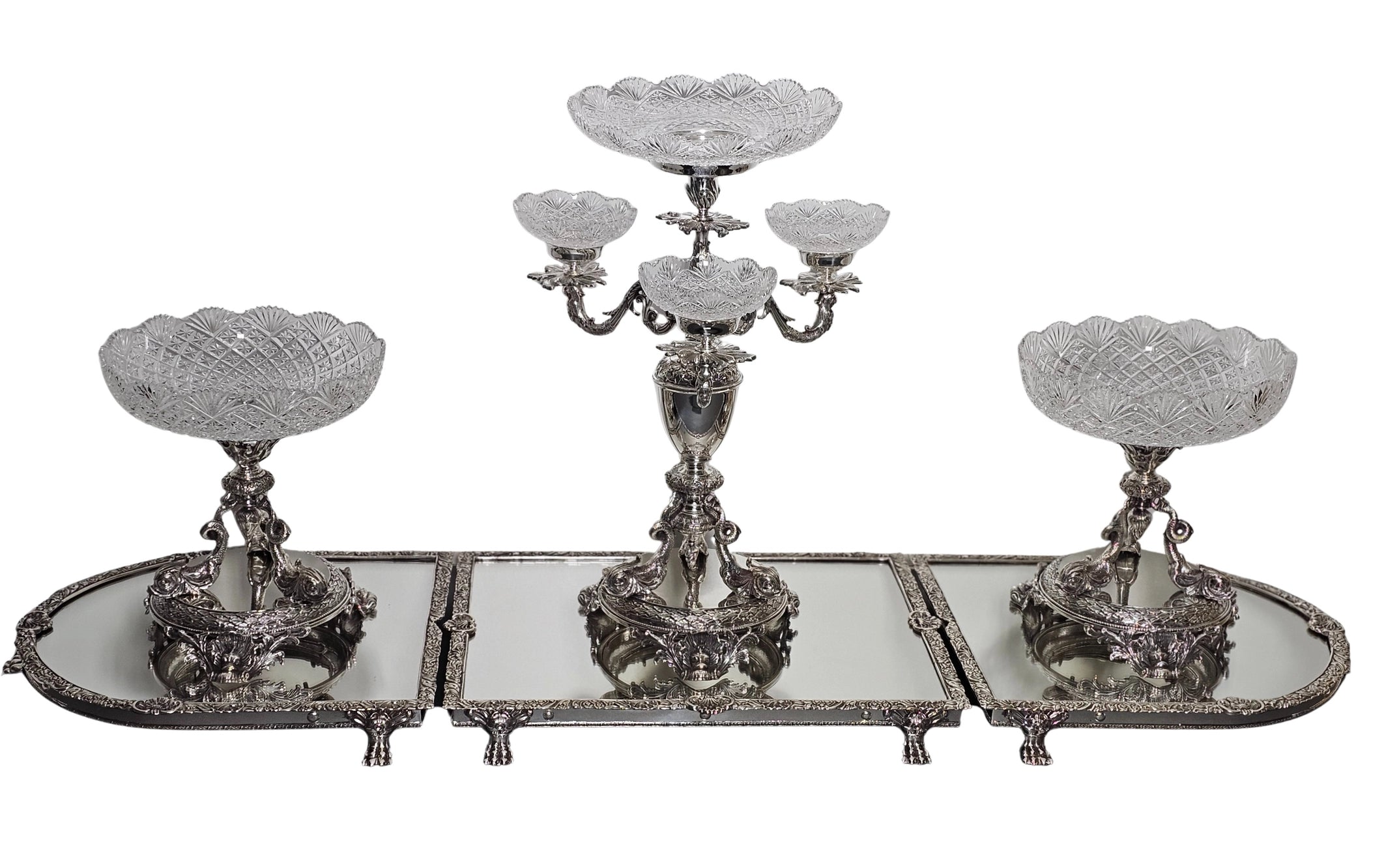 Decorative silver candelabrum with three candle holders on a white background