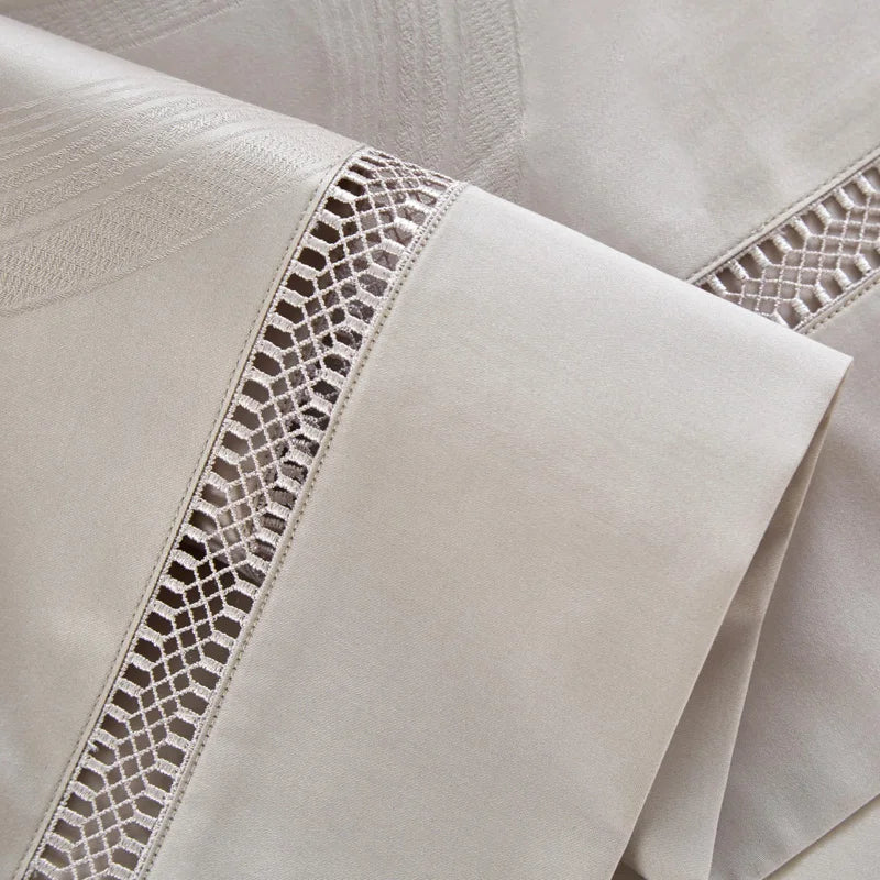 Close-up of beige fabric with intricate lace detailing