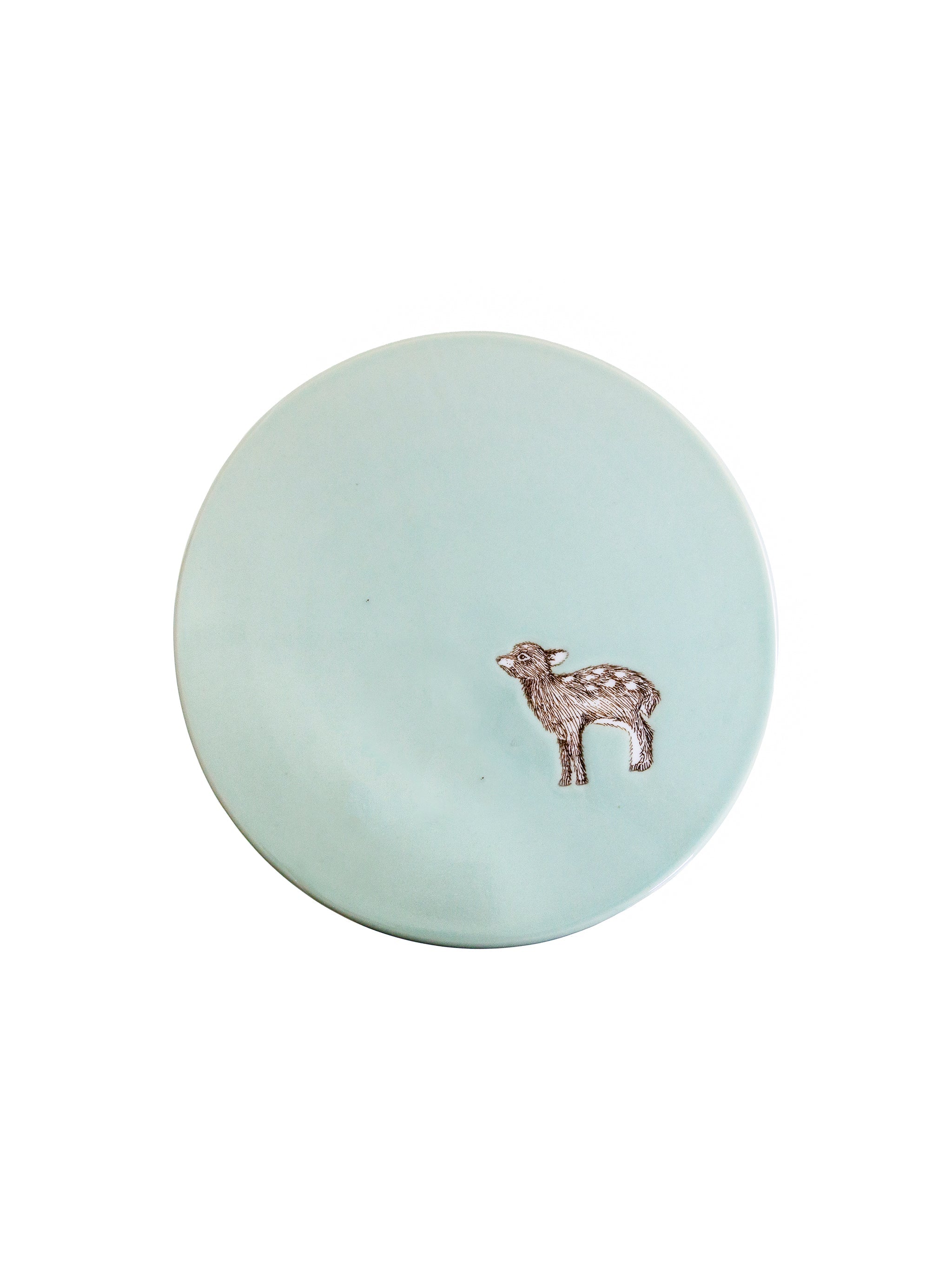 Round light blue cake stand seen from above with a small deer motif on a white background
