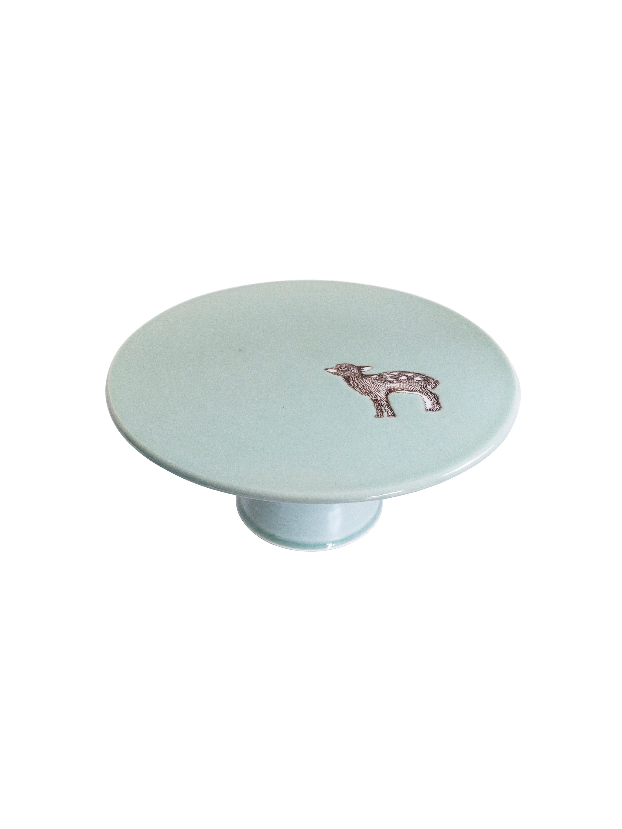 Round cake stand with a deer design on a white background