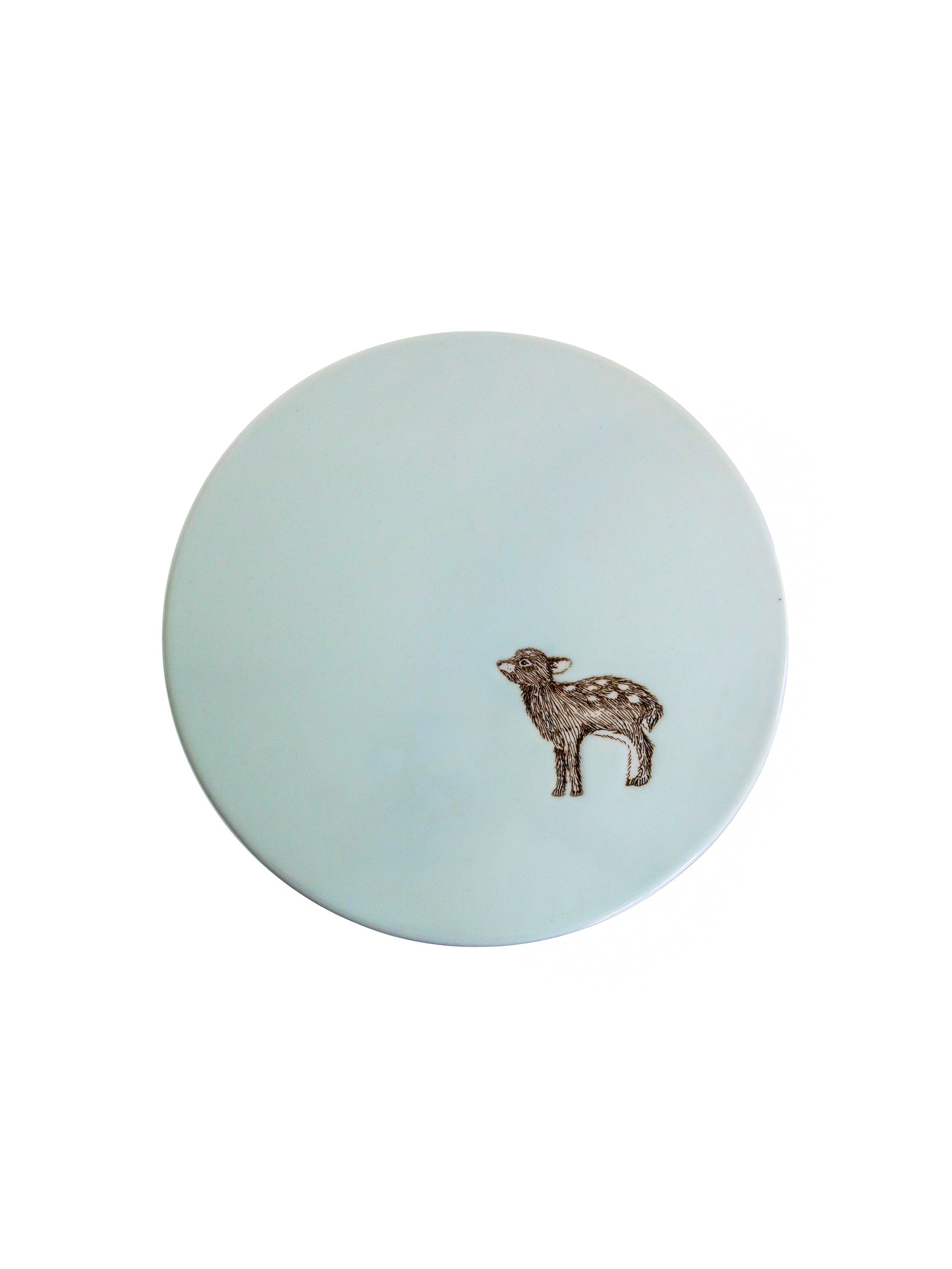Round light blue cake stand seen from above with a deer design on a white background