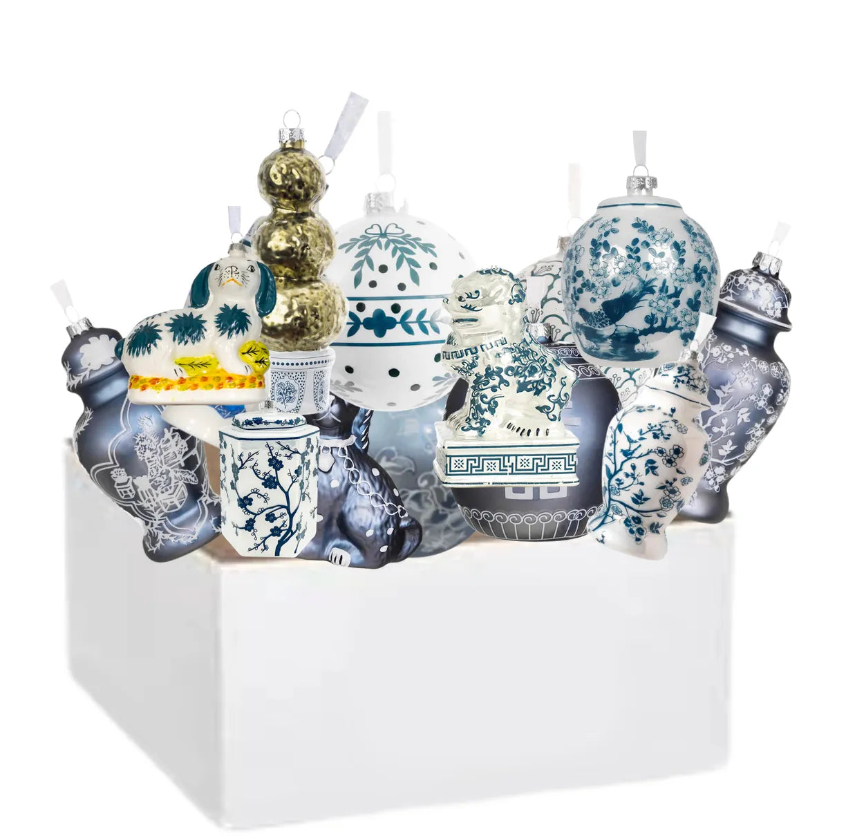 Collection of decorative holiday ornaments with blue and white patterns in a white box