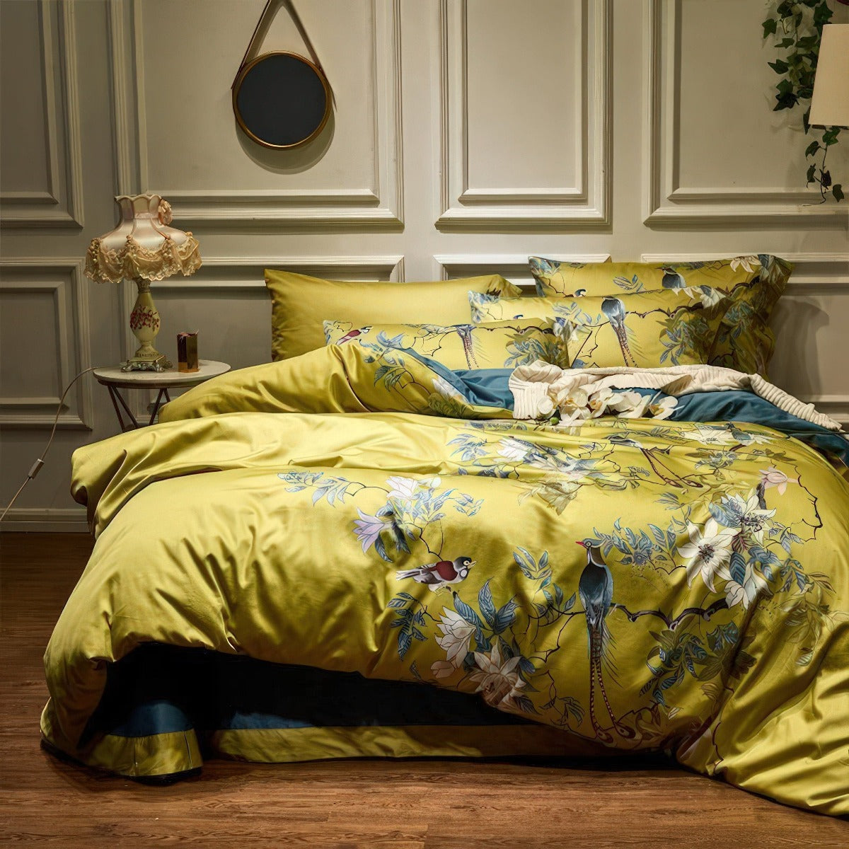 Yellow floral bedding set on a bed in a bedroom with decorative elements.