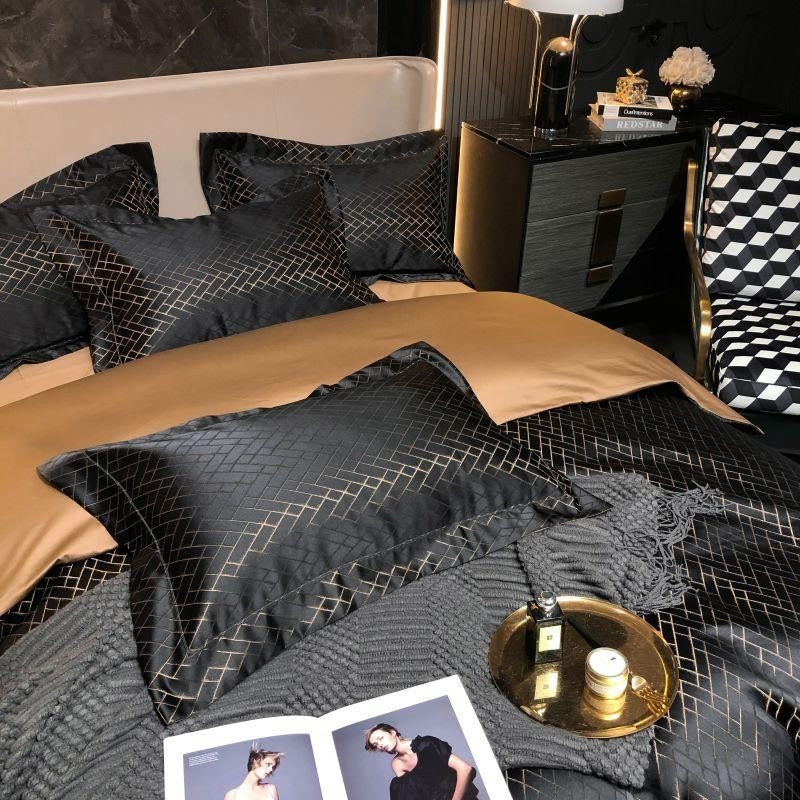 Neatly made bed with black and gold bedding in a modern bedroom setting.