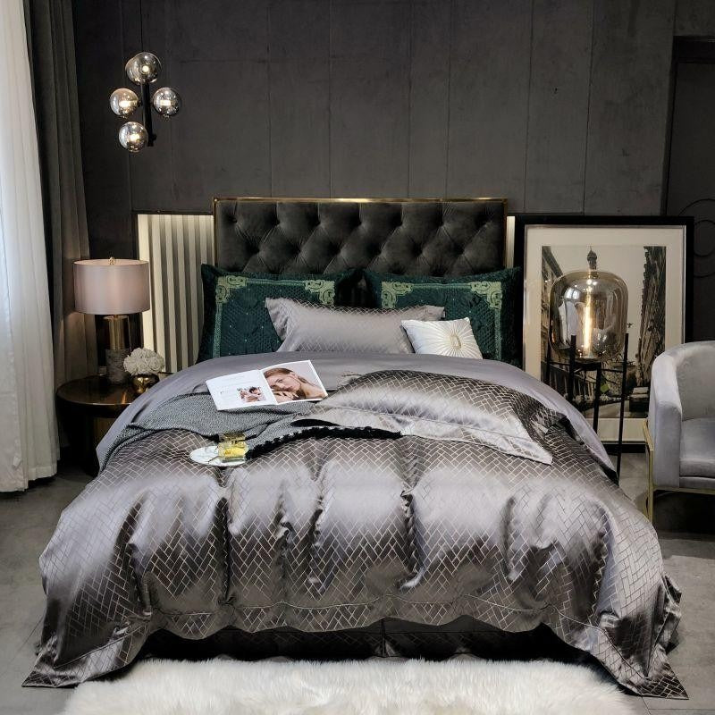 Modern bedroom with a bed featuring gray bedding and decorative pillows, against a dark wall.