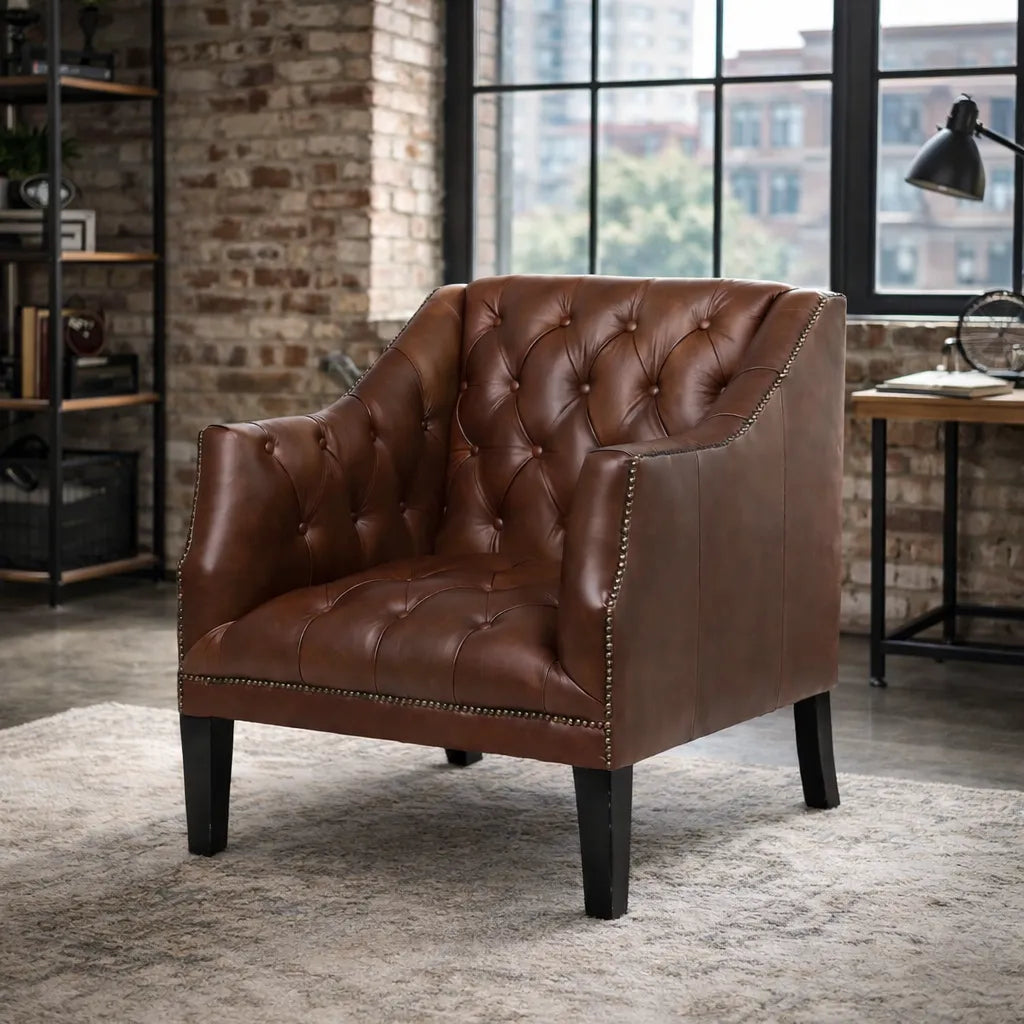Brown leather armchair in a room with brick walls and large windows.