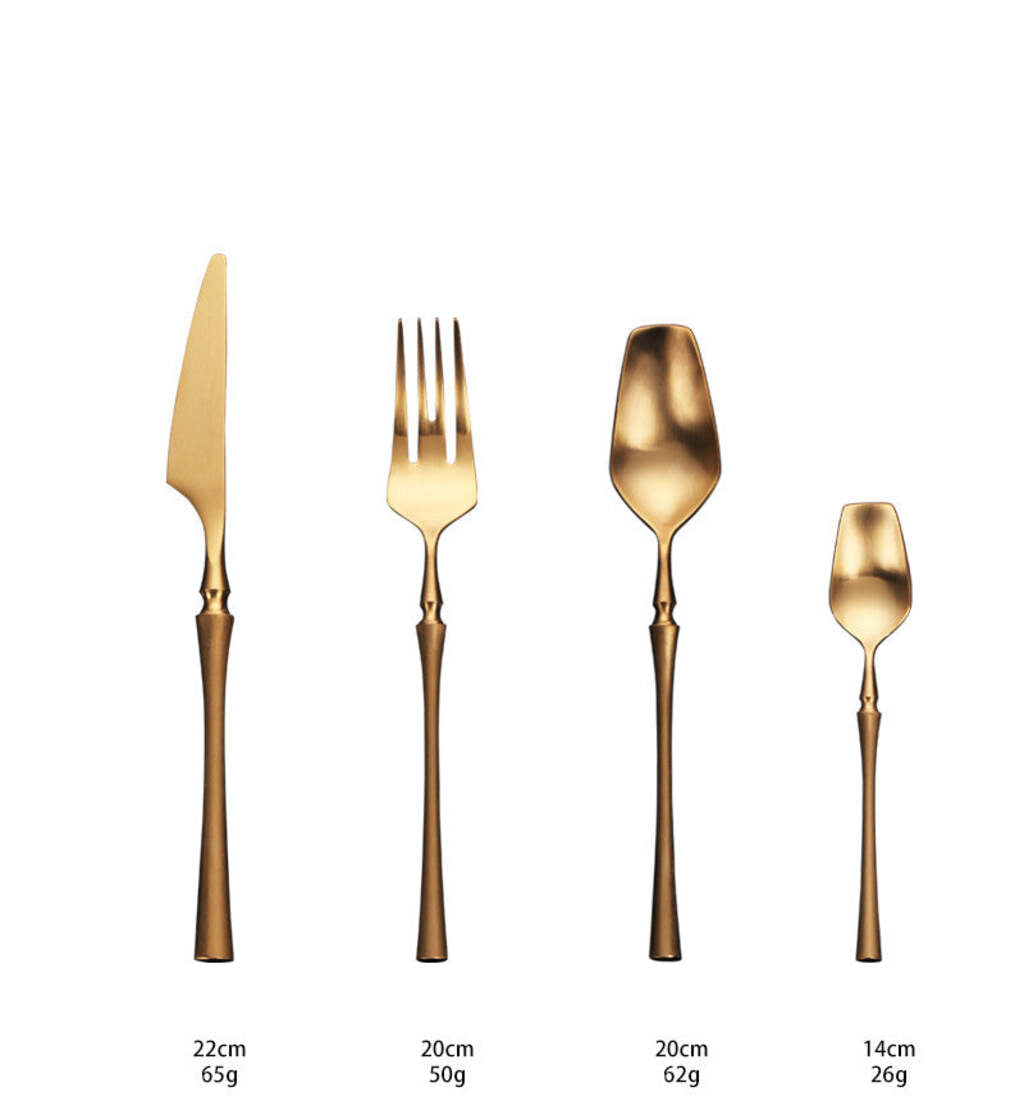 Set of gold cutlery including knife, fork, spoon, and teaspoon on a white background with measurements.