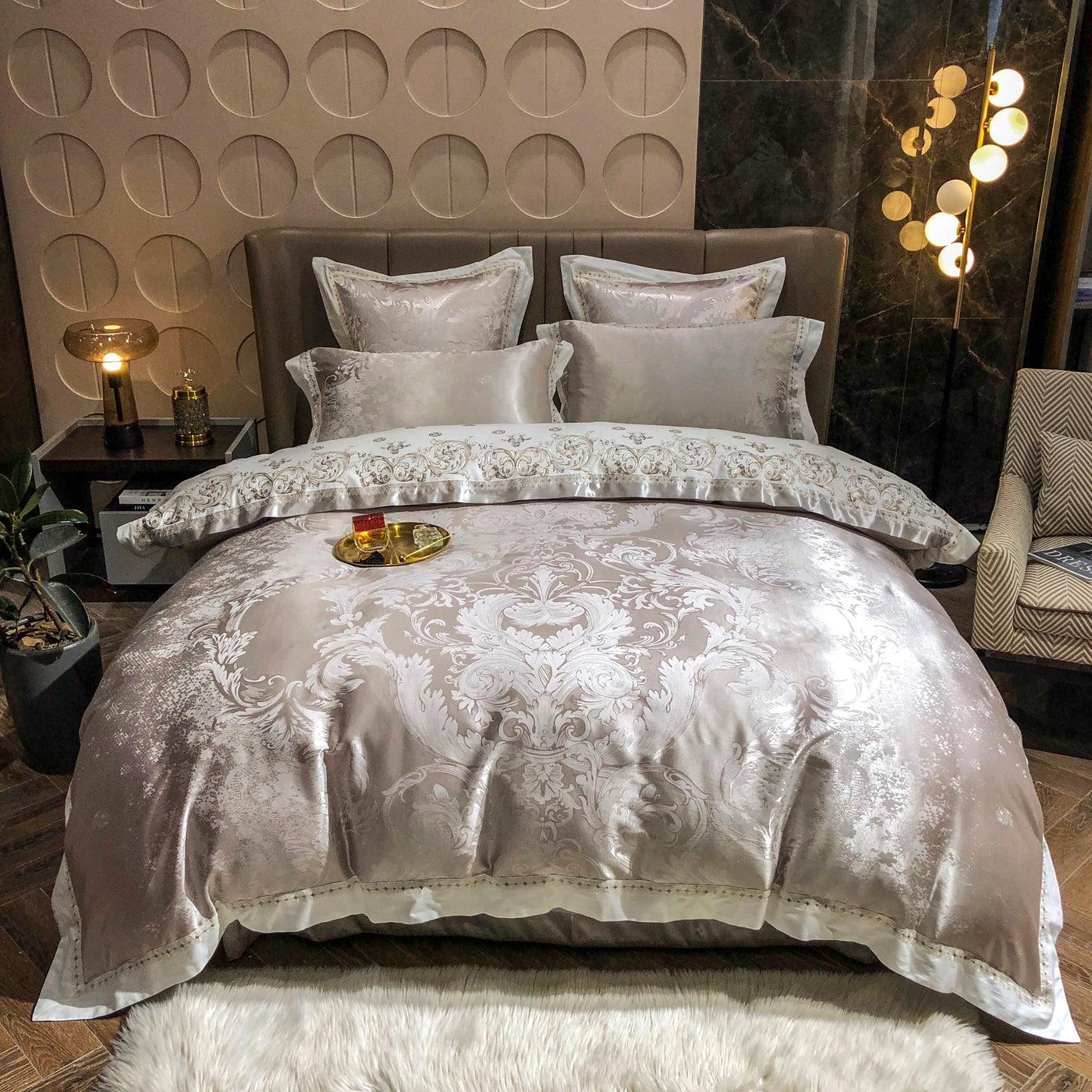 Decorative bedspread with intricate patterns in a bedroom setting.