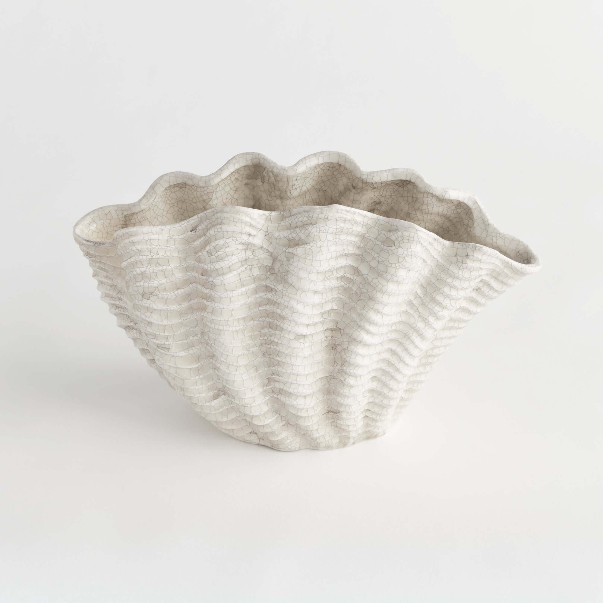 Shell-shaped decorative vase on a white background