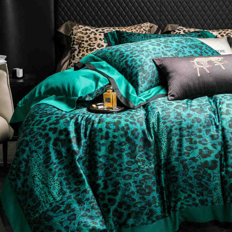 Teal leopard print bedding set on a bed with a dark headboard.