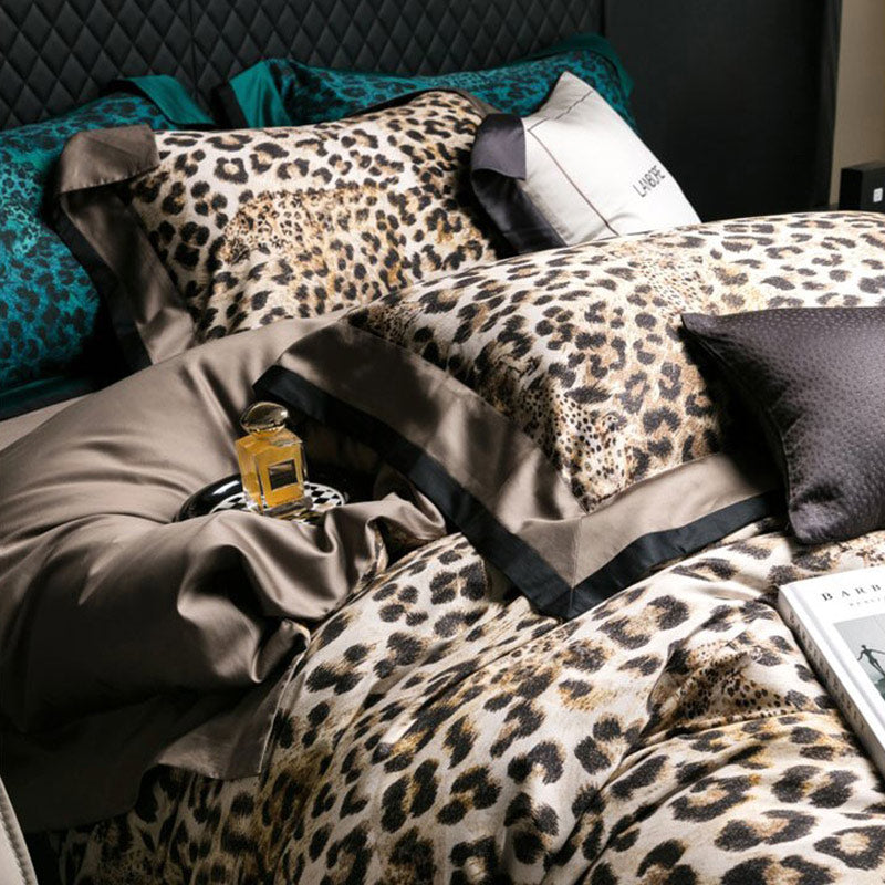 Bed with leopard print bedding and a bottle of perfume on a nightstand.
