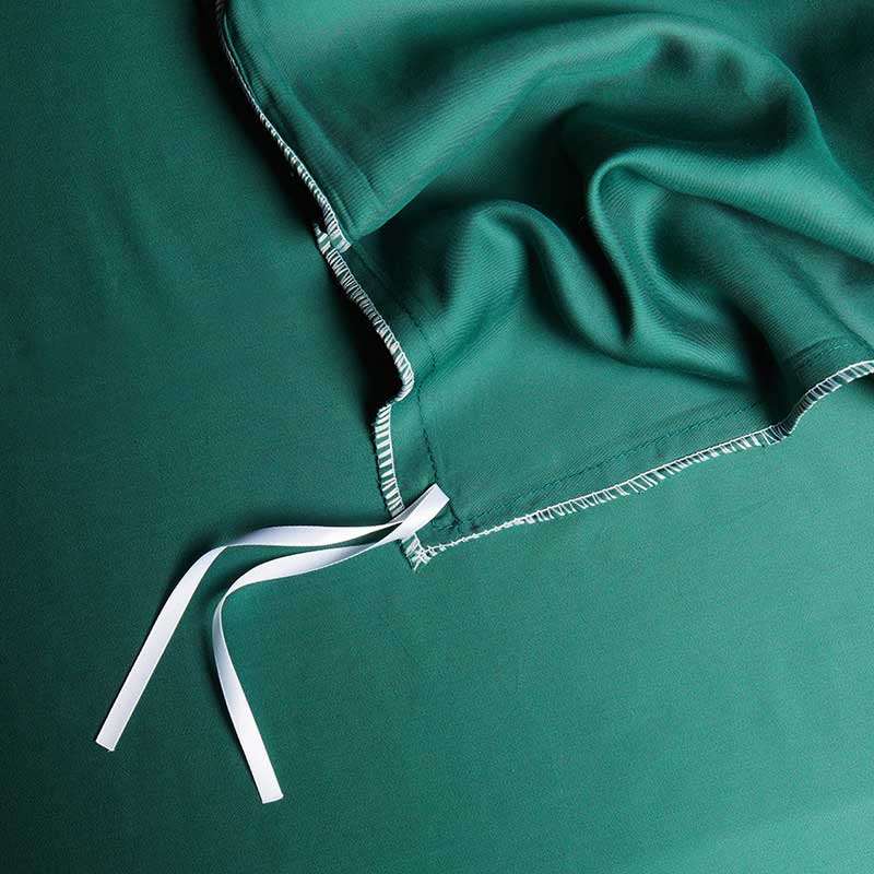 Close-up of a green garment with white trim