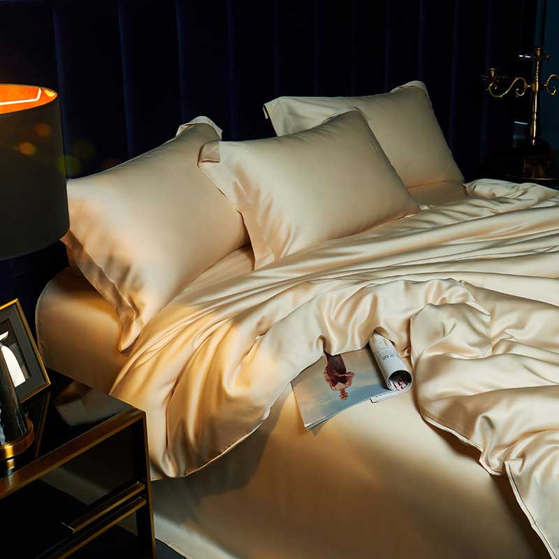 Neatly made bed with beige bedding in a dimly lit bedroom.
