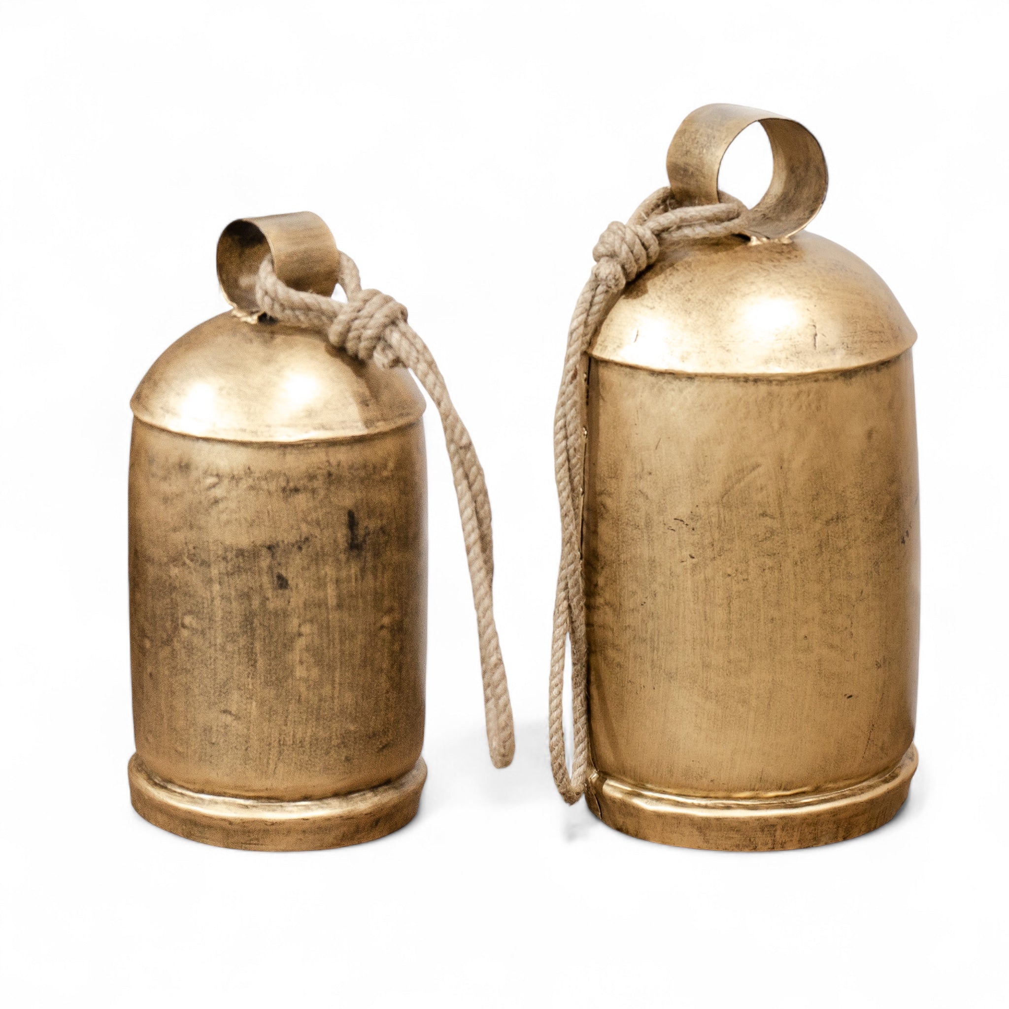 Two brass bells with ropes on a white background