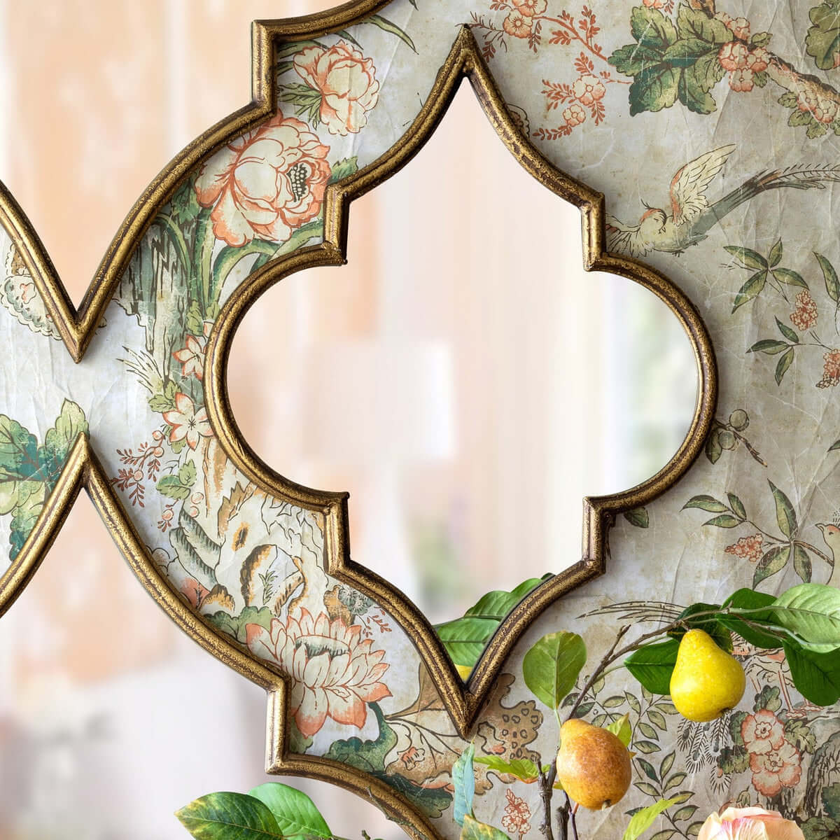 Decorative mirror with a floral wallpaper background