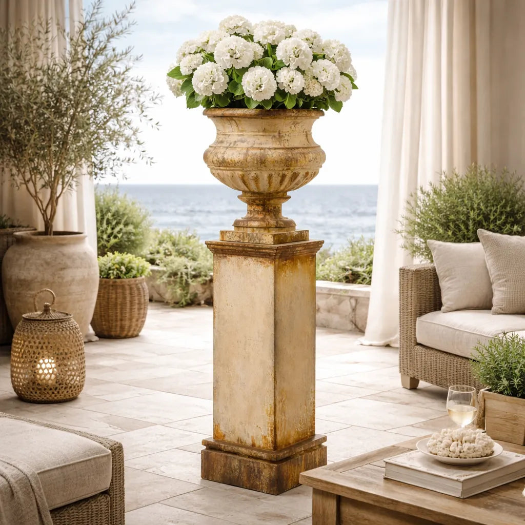 Outdoor patio with decorative urns, flowers, and seating area.