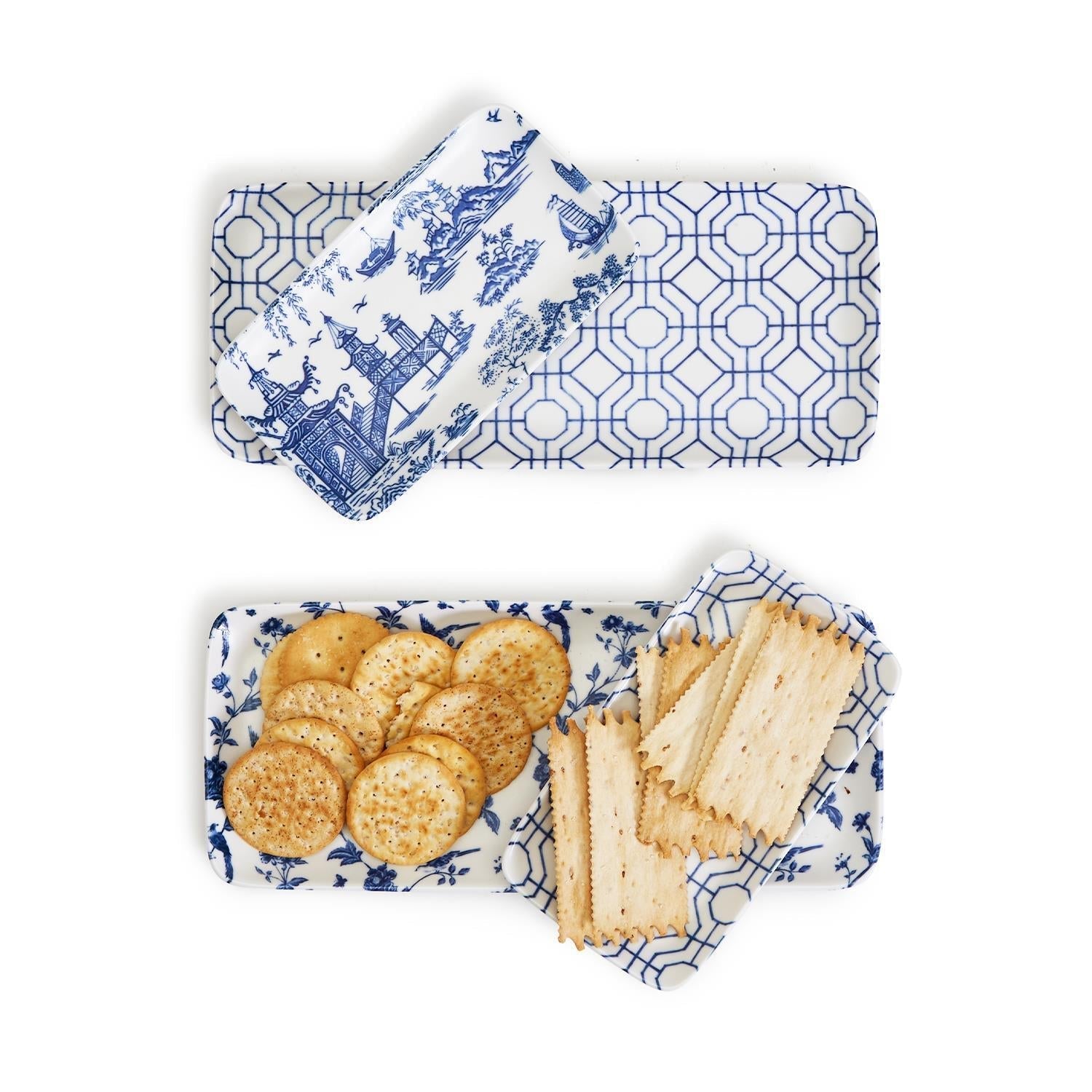 Rectangular serving trays with blue and white geometric pattern, filled with crackers, on a matching napkin.