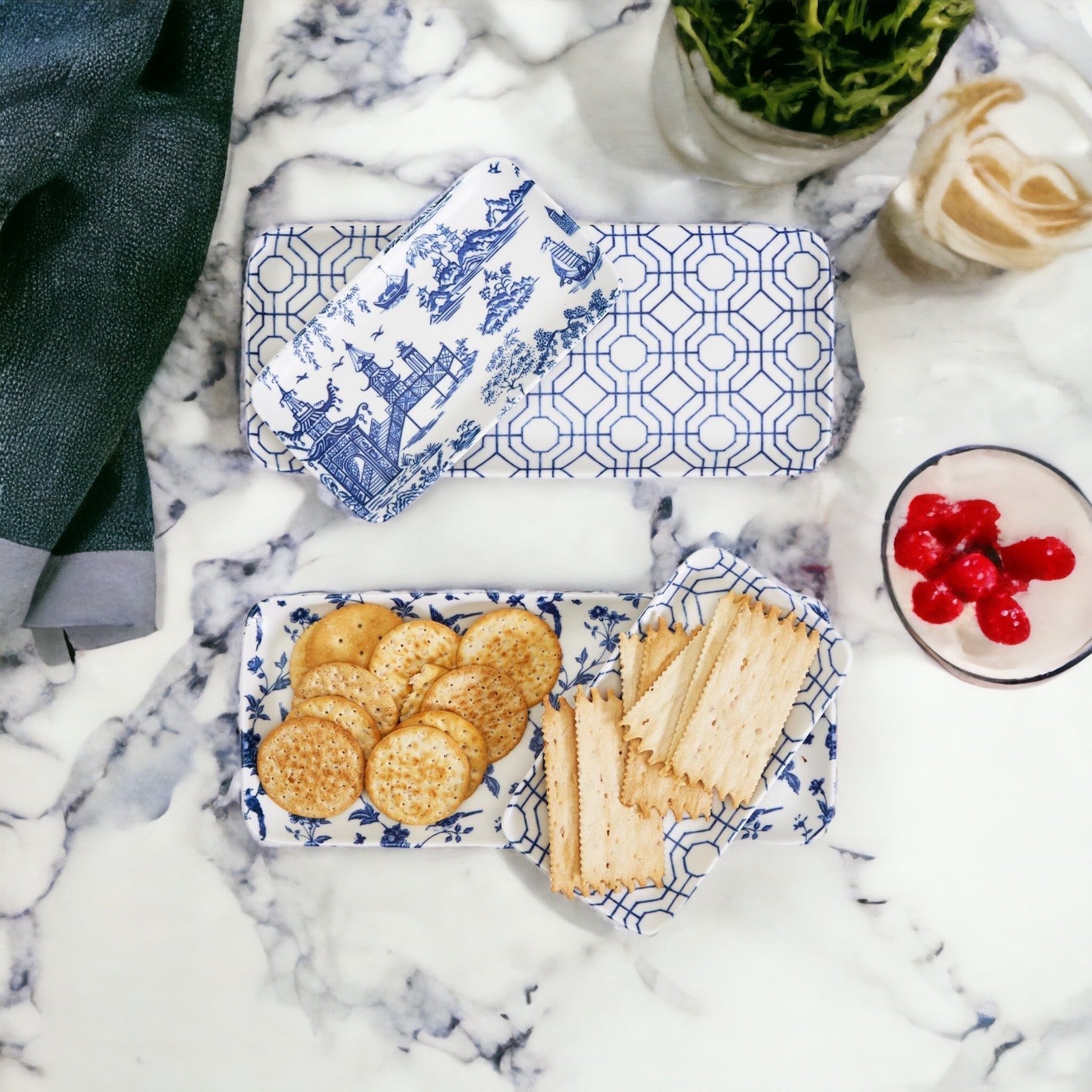 Blue and white patterned containers with snacks on a marble surface