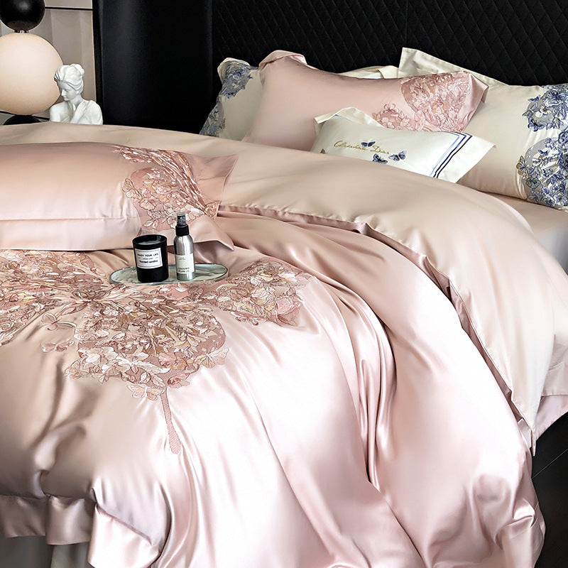 Pink satin bedding set featuring a pink butterly with decorative elements on a bed.
