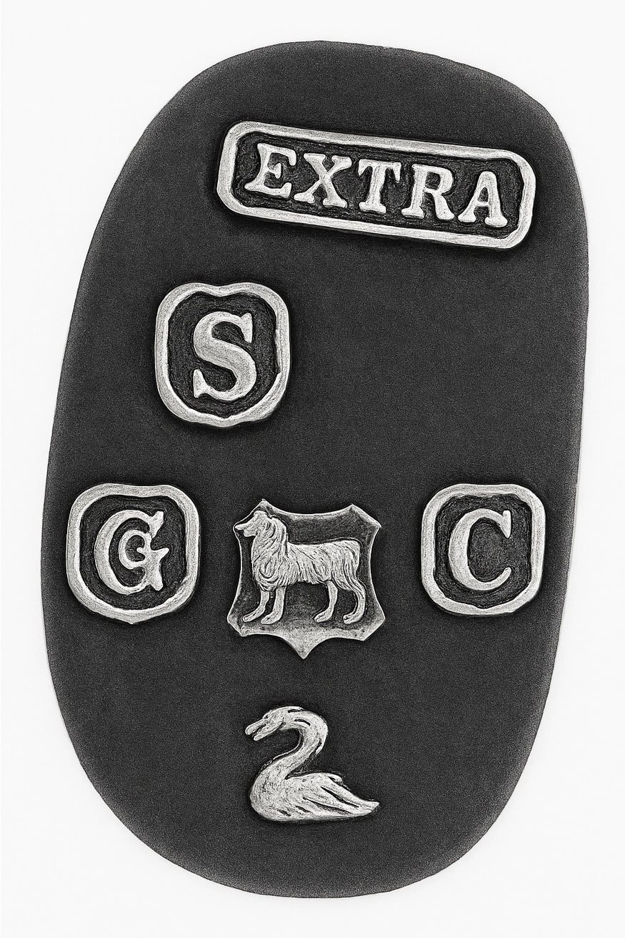 Underside of English silver plate sauceboat showing maker-style marks including EXTRA stamp, crest motif, and decorative pseudo hallmarks