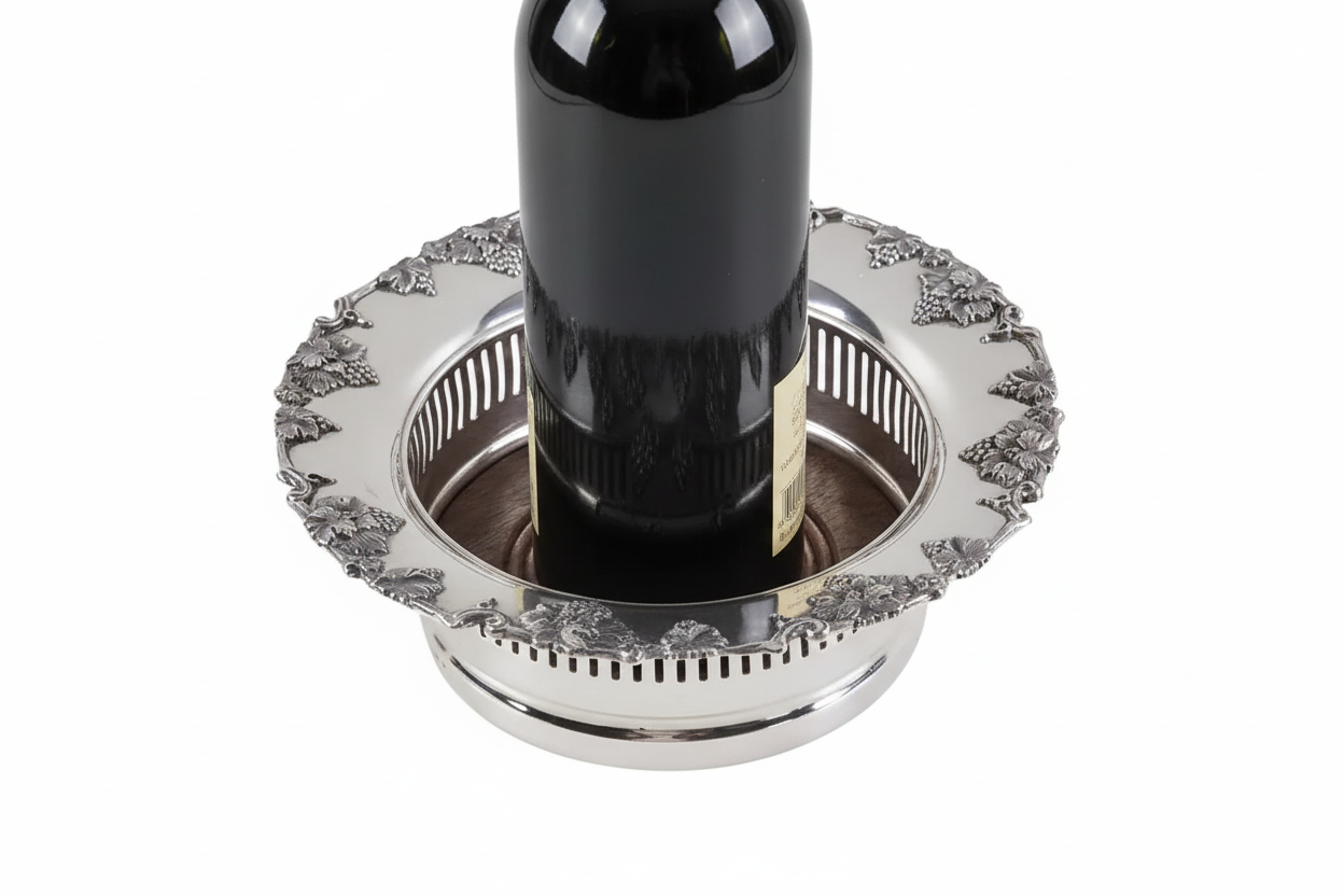 English silver plate wine coaster holding a wine bottle on a white background