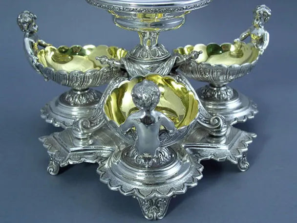 Decorative silver and gold epergne on a blue background