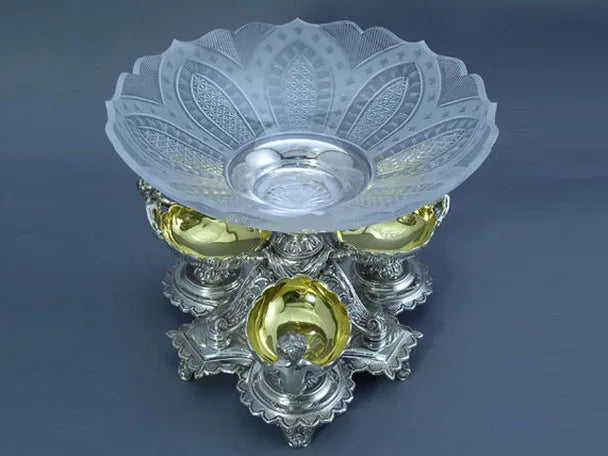 Decorative glass bowl with intricate designs on a dark background