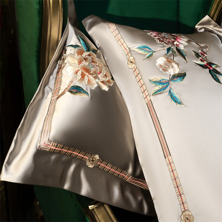 Decorative pillow with floral embroidery on a green background