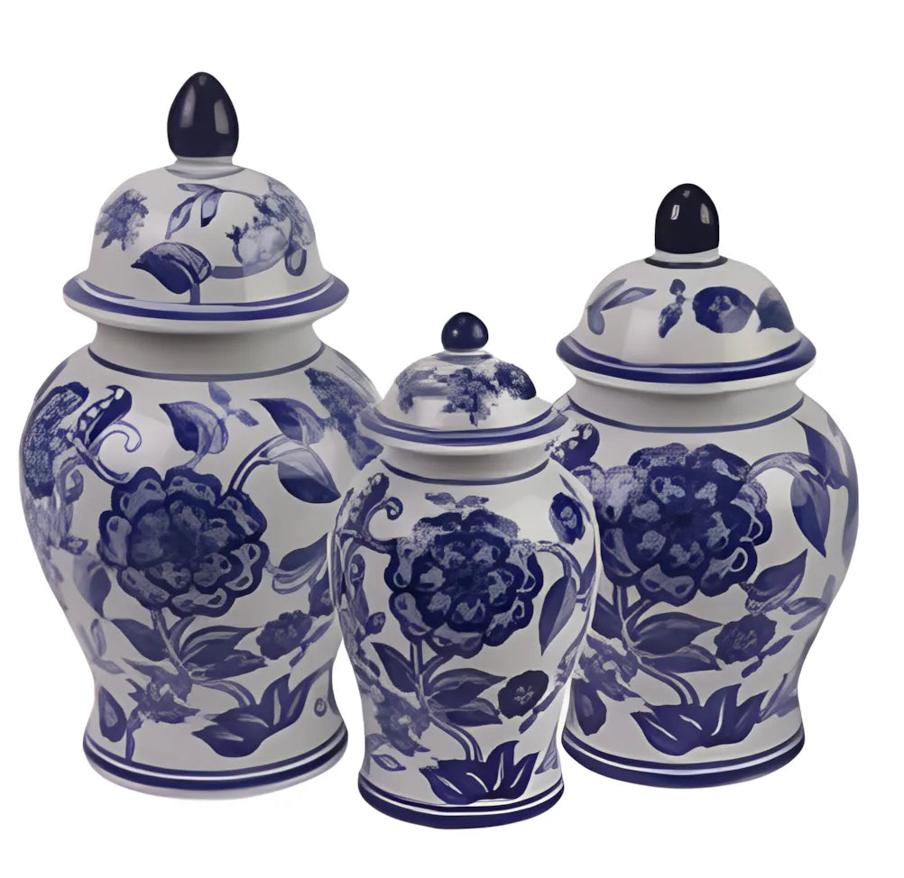 Set of three blue and white floral-patterned ceramic jars with lids on a white background
