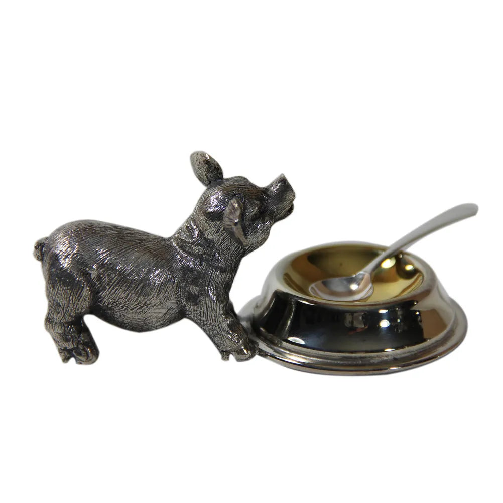 Silver plated pig salt cellar and spoon on a white background