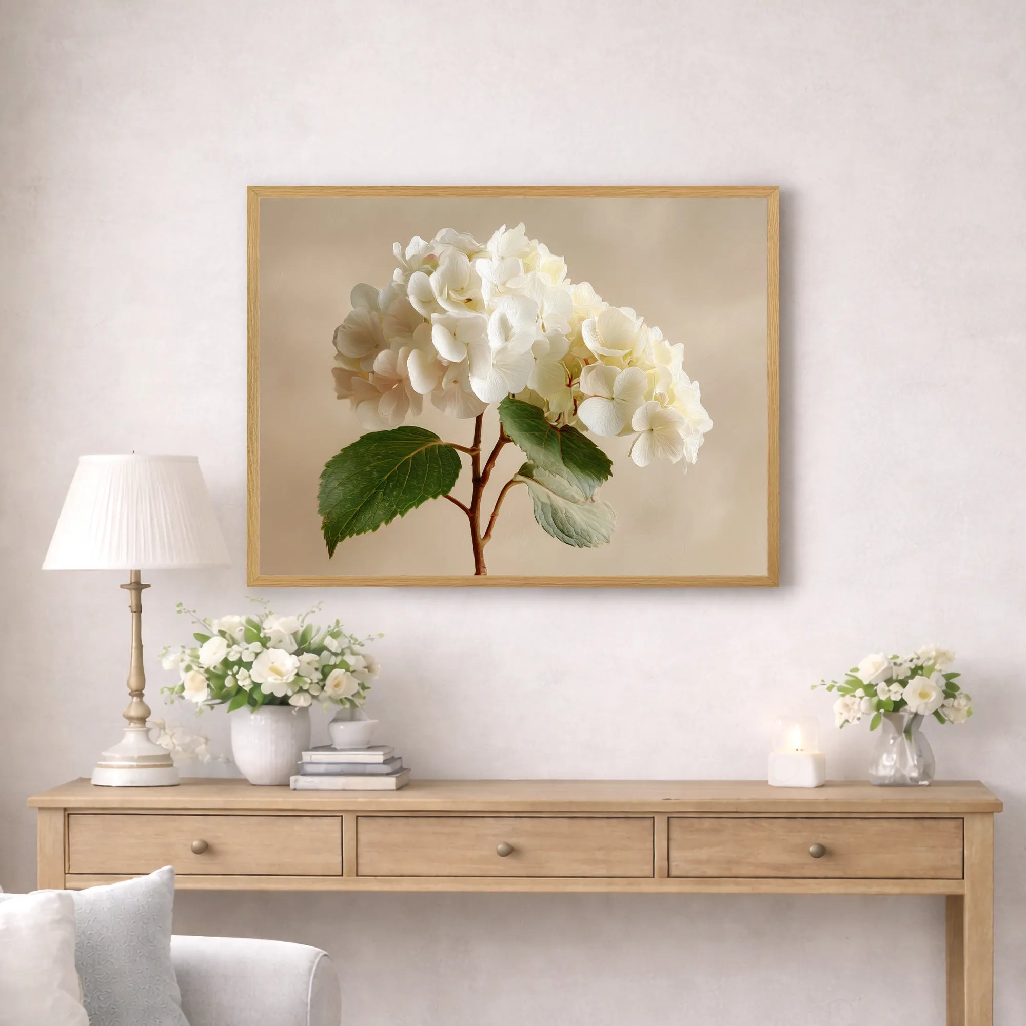 Framed hydrangea artwork above a wooden console table with decorative items.
