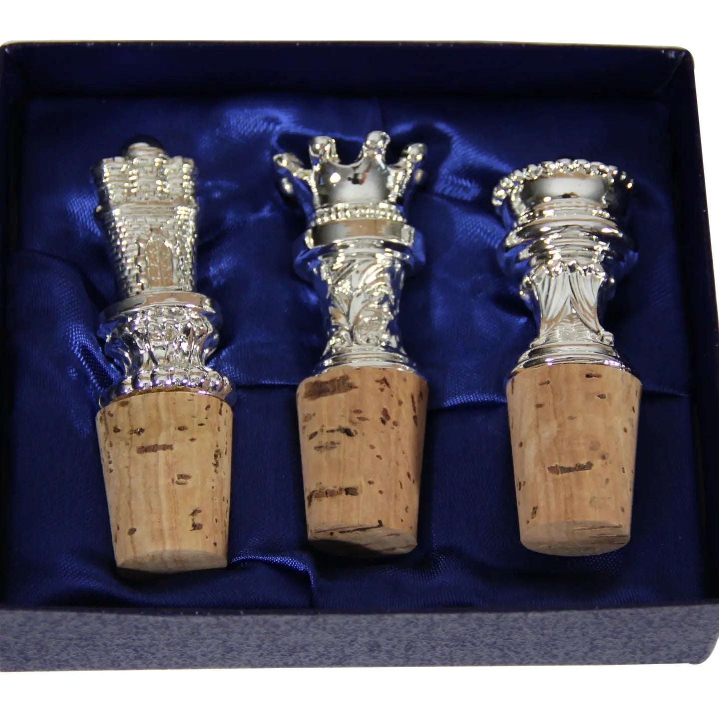 Set of three silver plate wine bottle stoppers with crown-shaped tops and natural cork bases in a box with blue satin lining