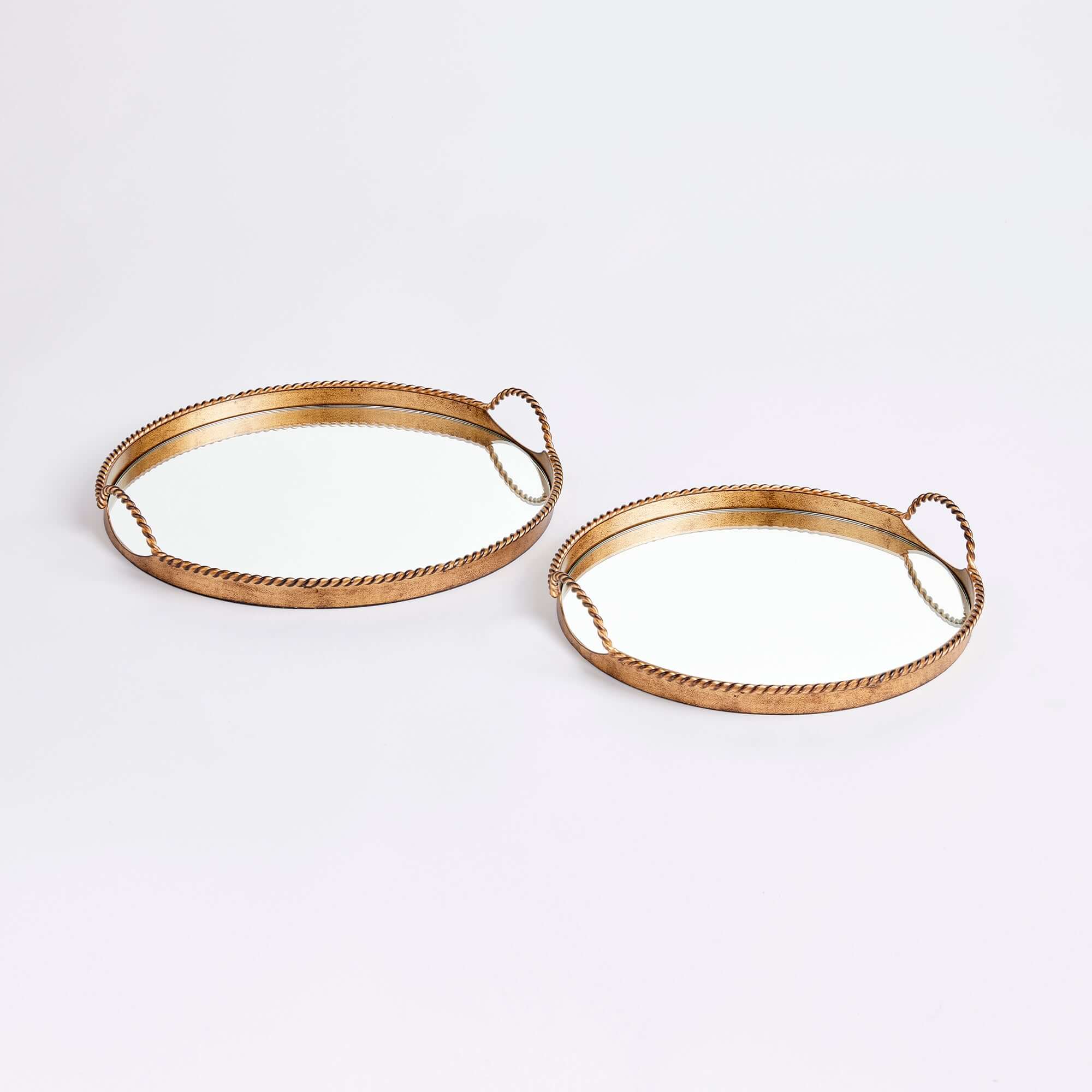 Two gold decorative trays with handles on a white background