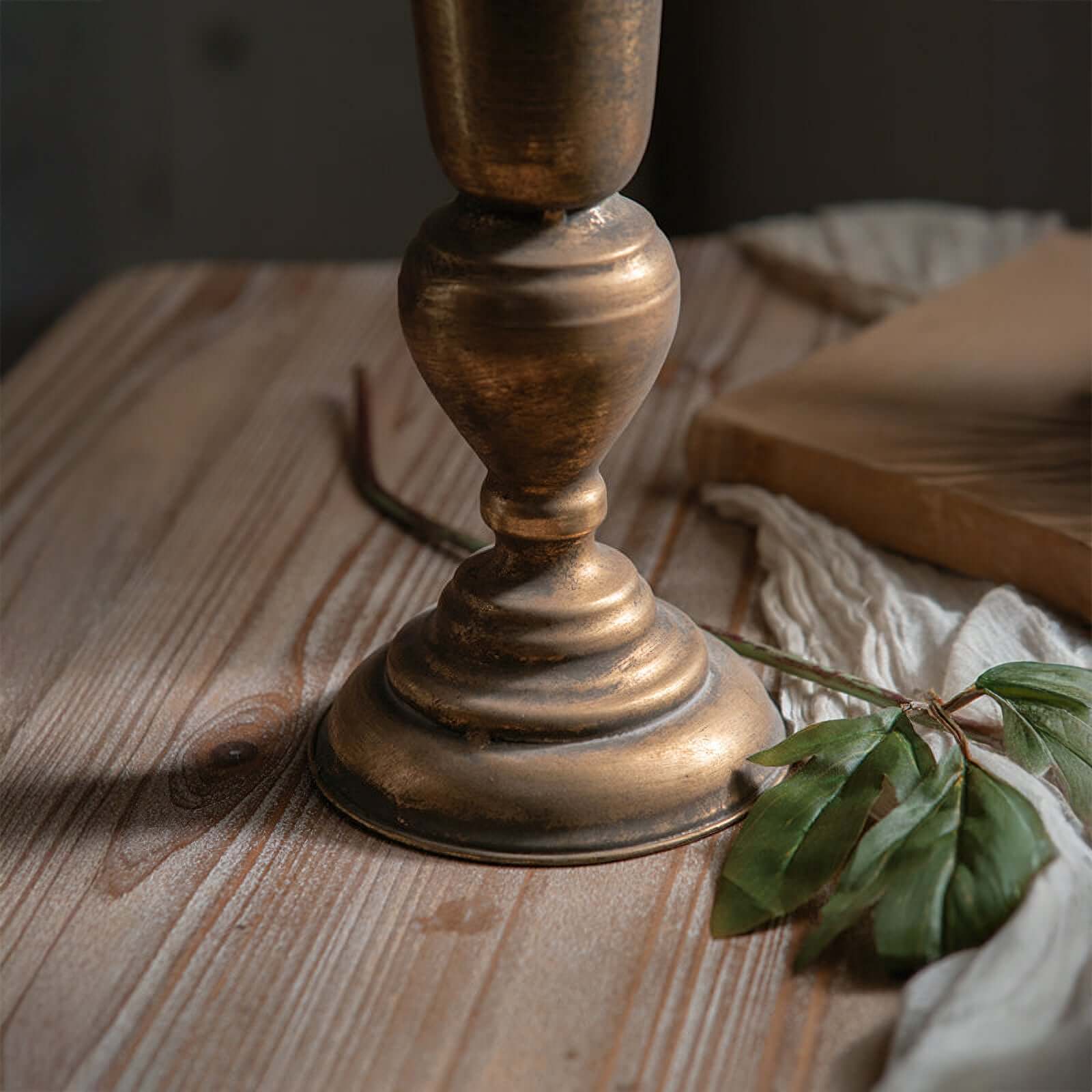 Bronze candlestick on a wooden surface with a soft focus background