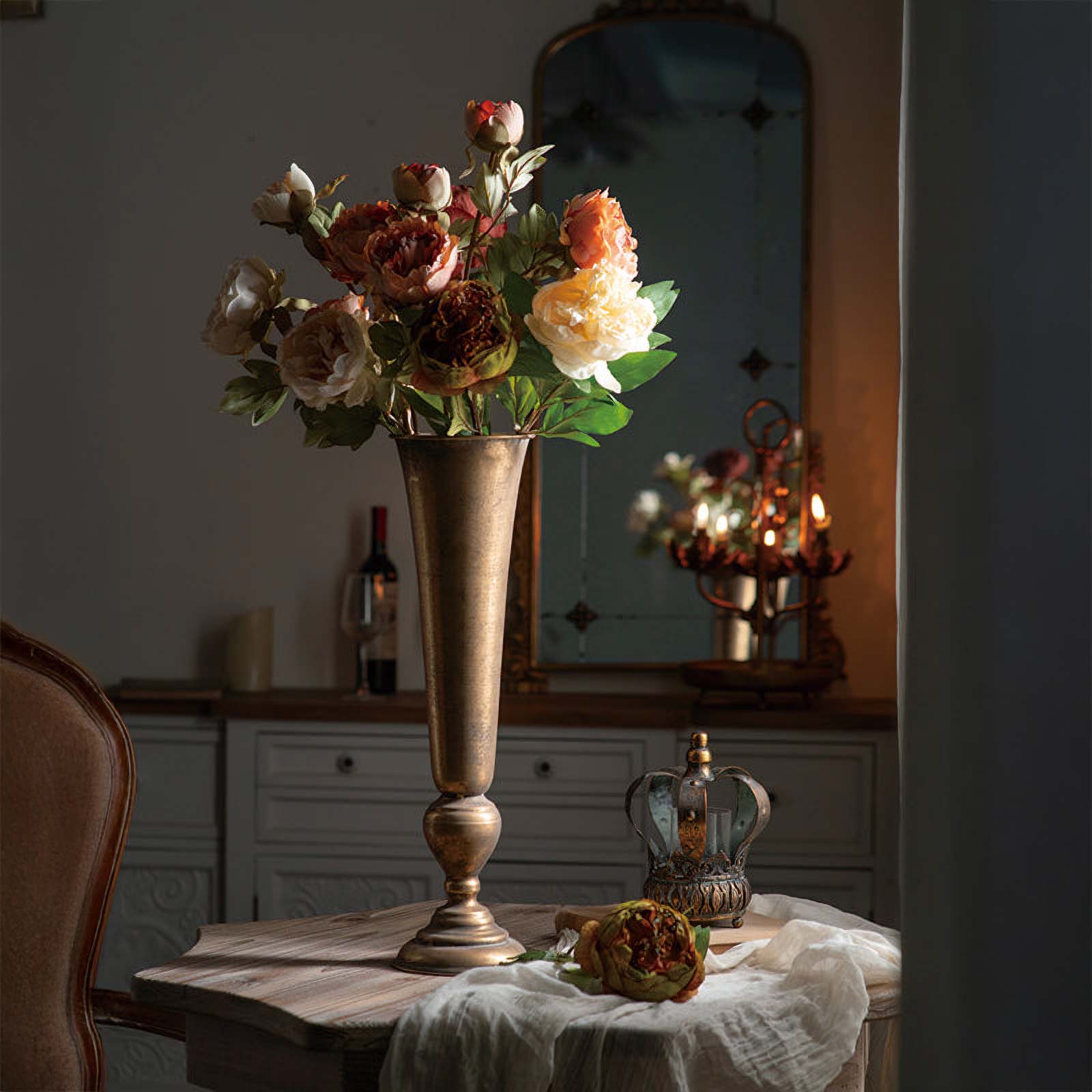Decorative vase with flowers on a table in a dimly lit room