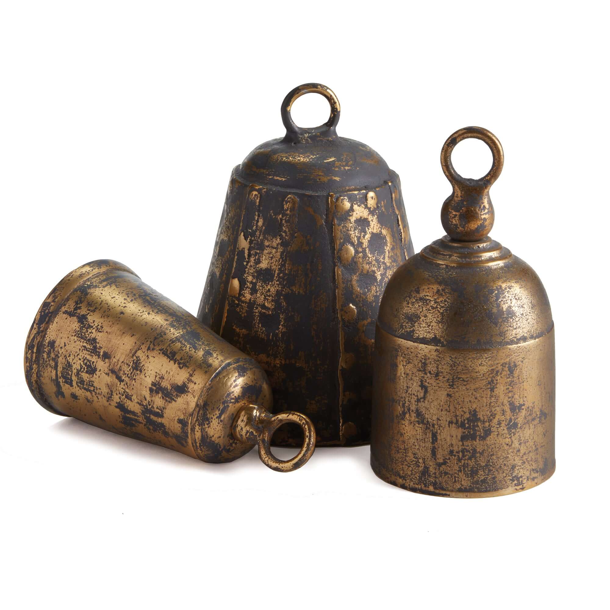 Three rustic brass bells on a white background