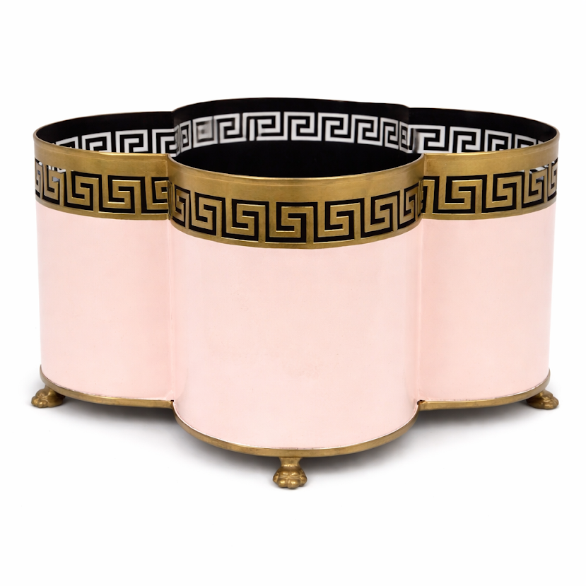 Decorative pink planter with gold and black decorative elements on a white background