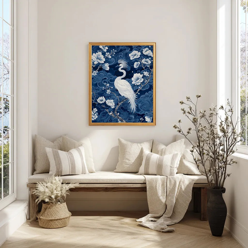 Framed artwork of a crane and flowers on a wall above a bench with pillows.