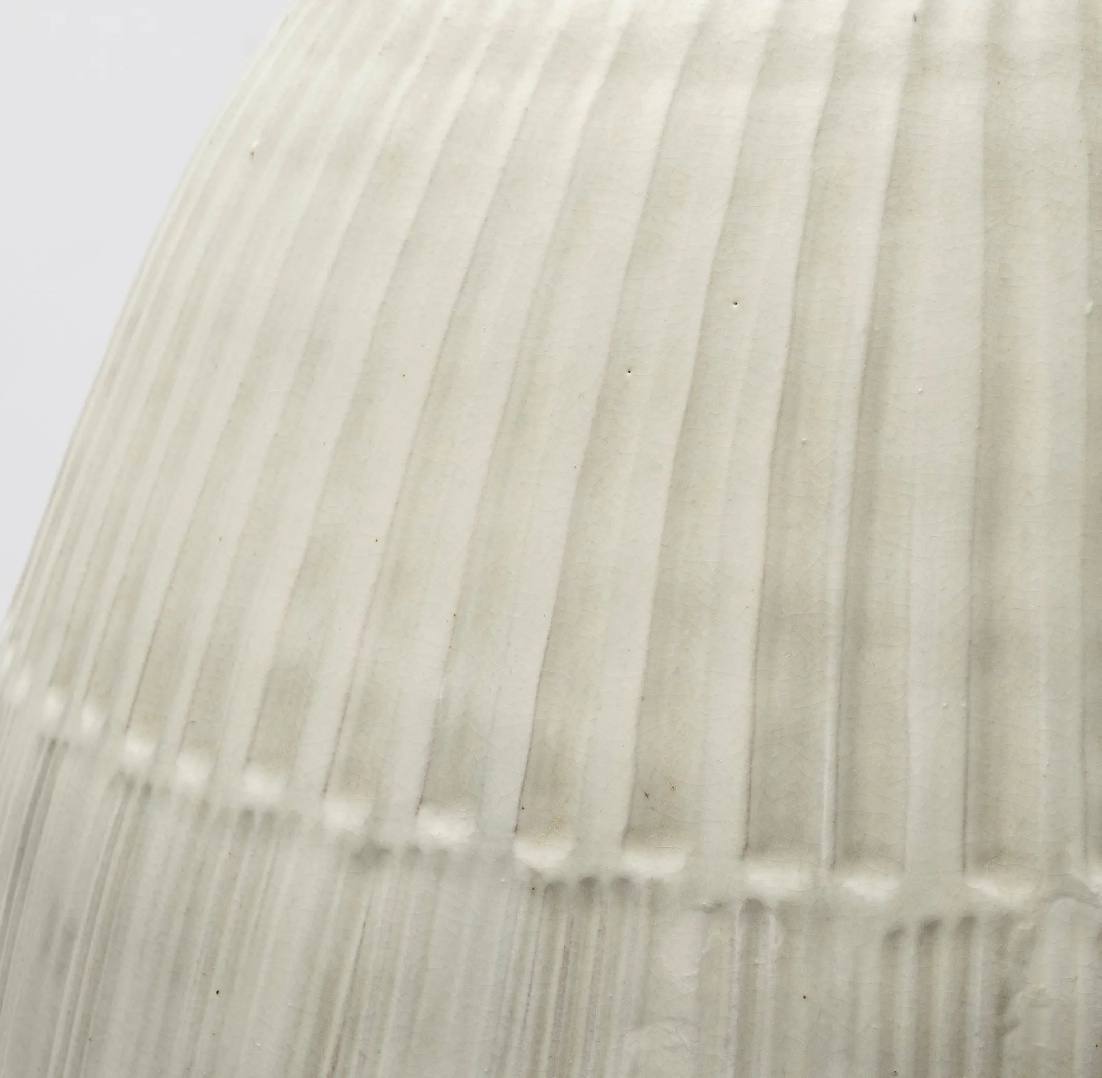 Close-up of a textured white surface with vertical lines