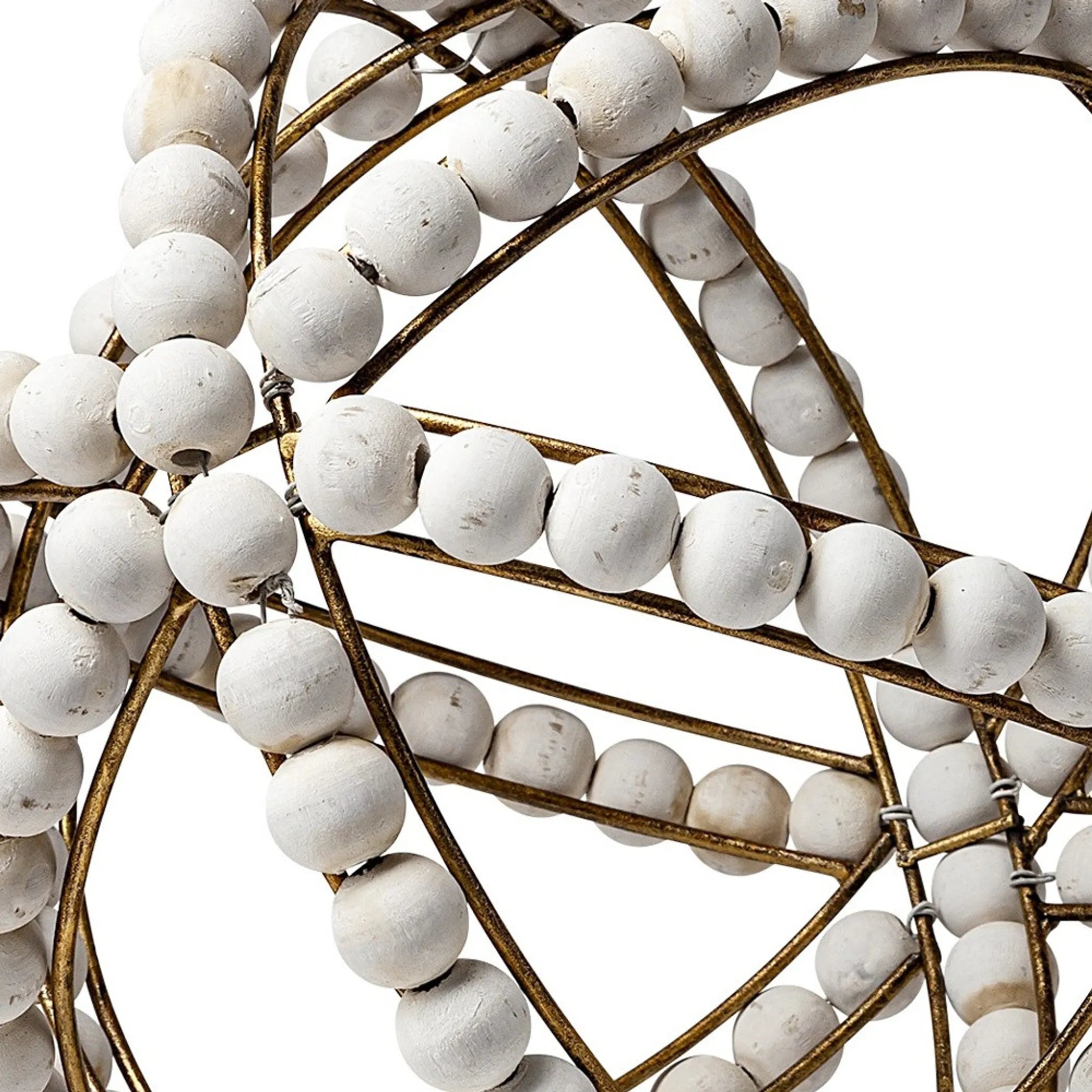 Close-up of a decorative object with white beads and gold metal frame on a white background