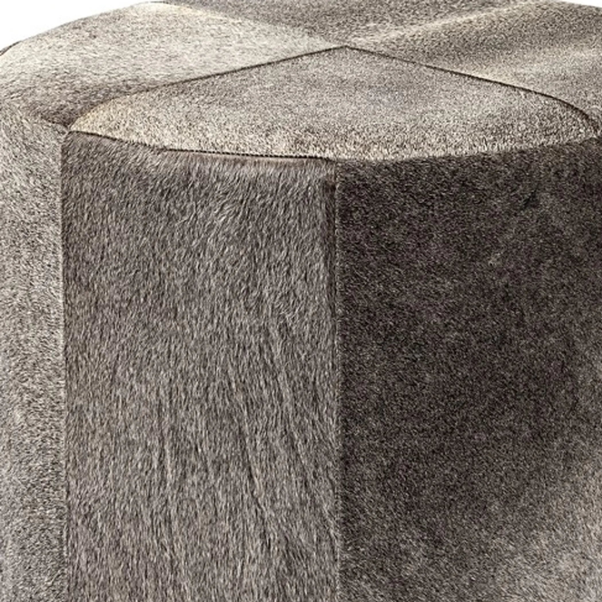 Close-up of the side of a gray brown wool ottoman with a diamond-shaped top.