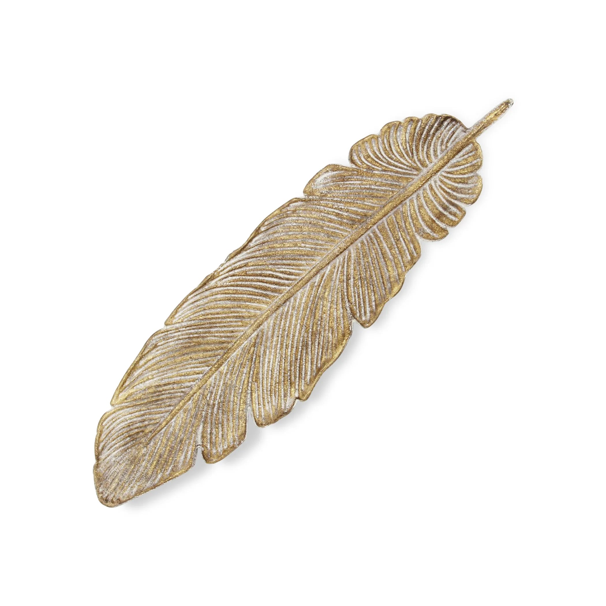 Overhead view of a decorative gold feather tray on a white background