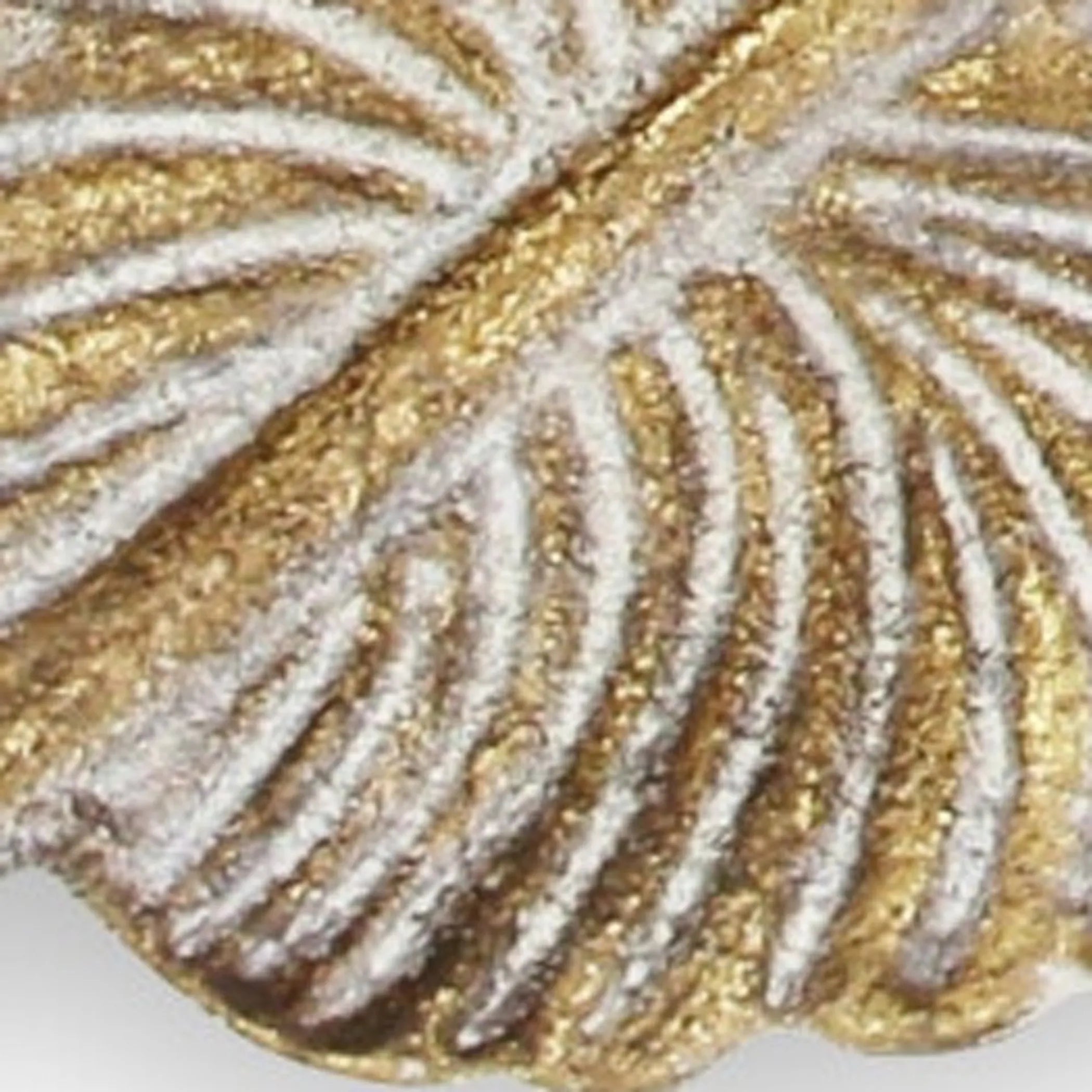 Close-up of a gold and silver decorative leaf pattern tray