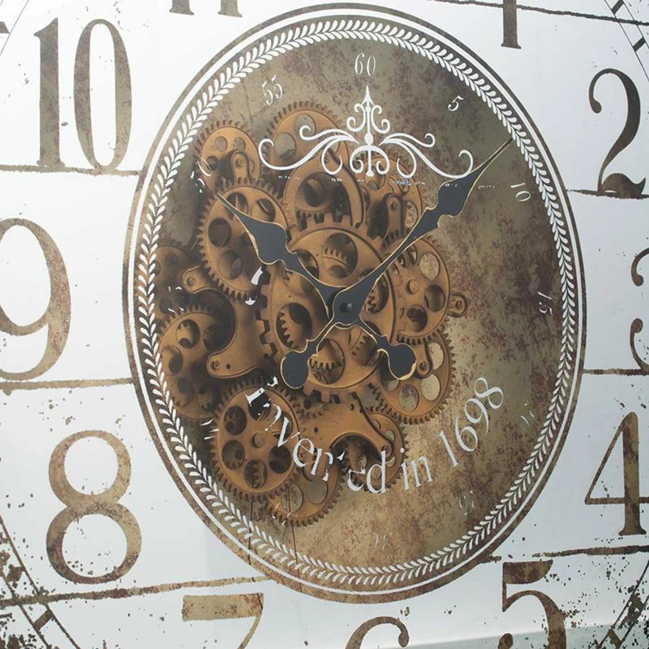 Decorative clock face with mechanical design and 'Invented in 1698' text.