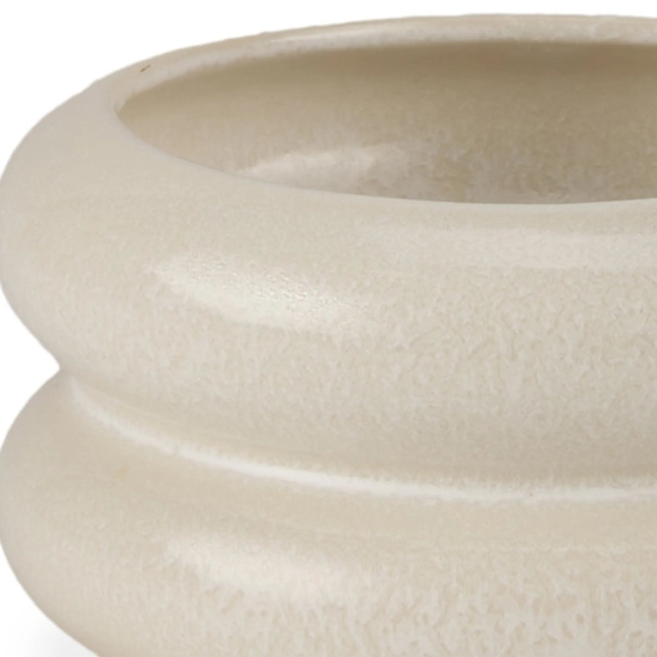 Close-up of a beige ceramic planter with a textured surface on a white background