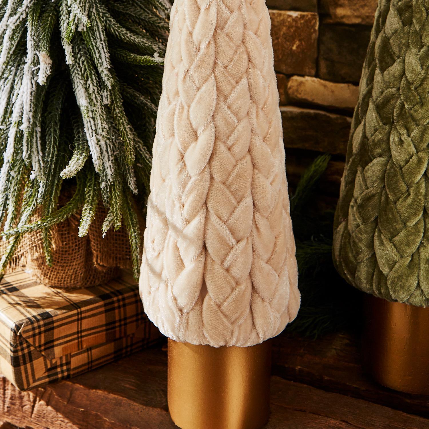 Close-up of a braided velvet Christmas decorative tree in a cozy indoor setting with Christmas decorations.