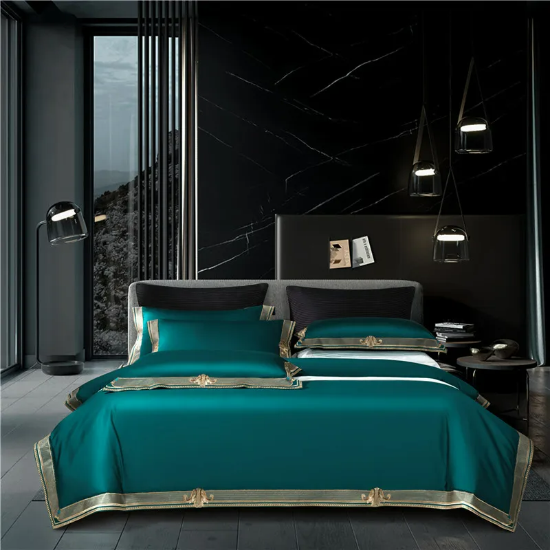 Teal bedspread with gold accents on a bed in a modern bedroom setting.
