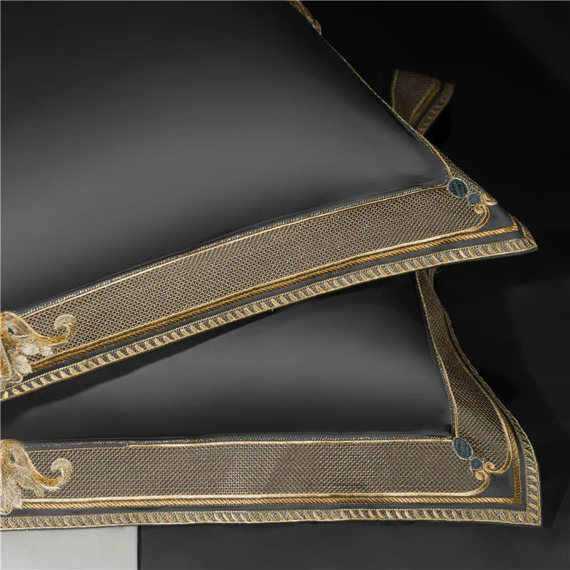 Decorative black pillow with gold embroidery on a dark background