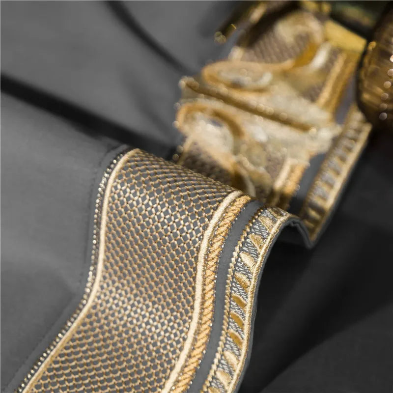 Close-up of a textured gold and black bedding on a dark background