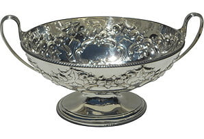 Silver decorative bowl with handles on a white background